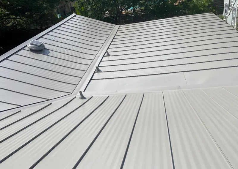 Solar attic fan installed on a metal roof for Roof Ventilation in Fair Lawn